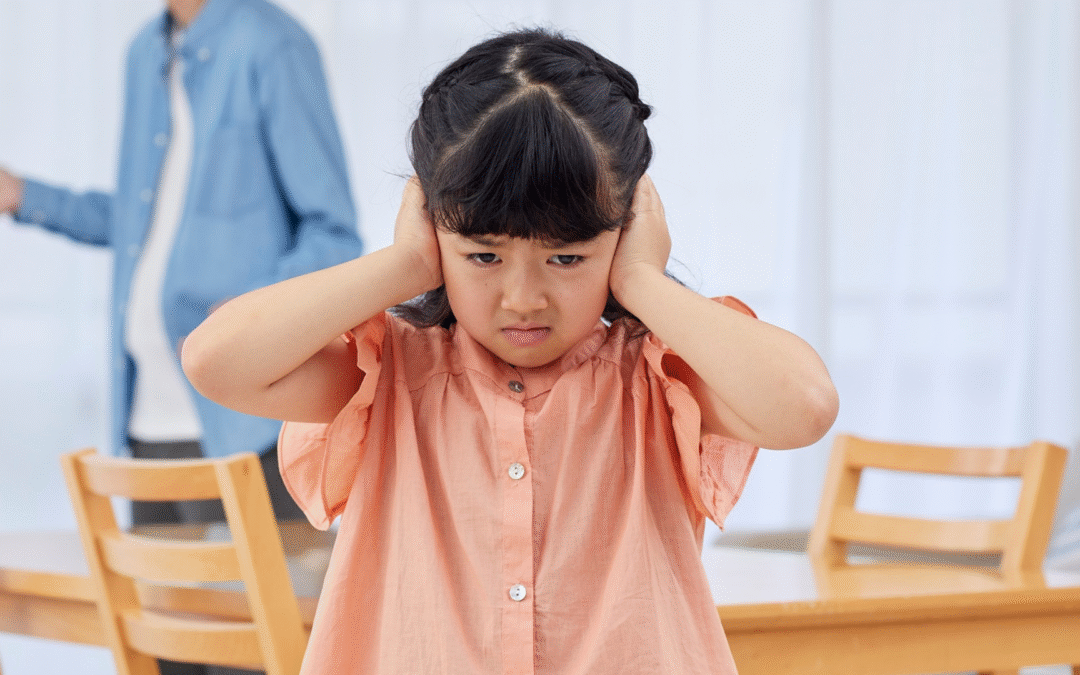 Little girl putting hands over ears